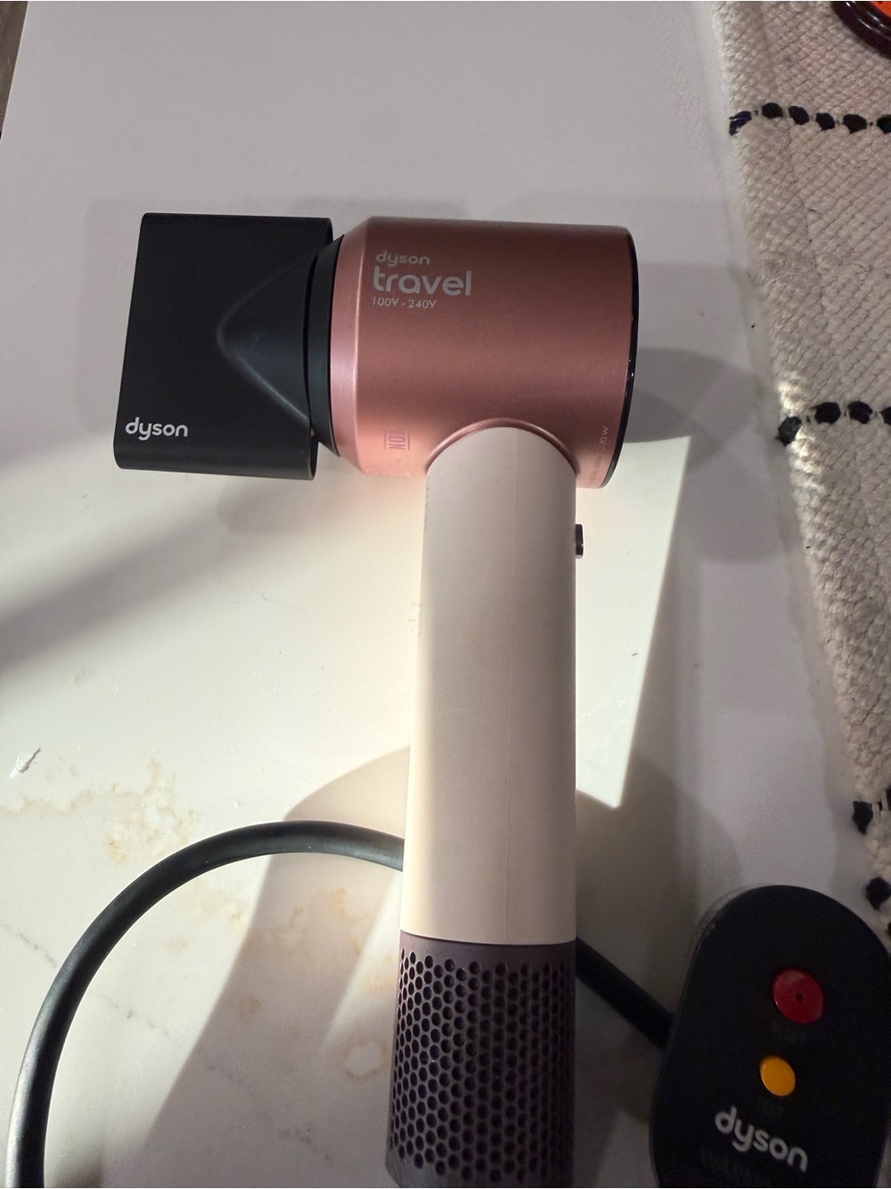 Dyson hair dryer in pink and black with rose-gold trim